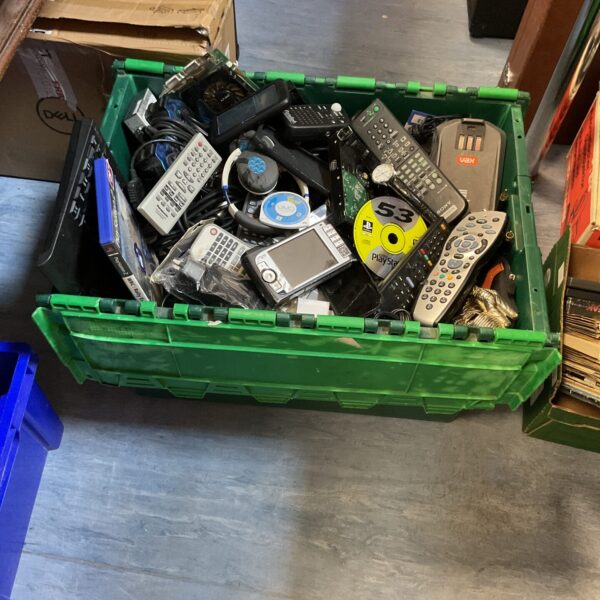 Mixed electrical and gaming lot with remotes and IT components.