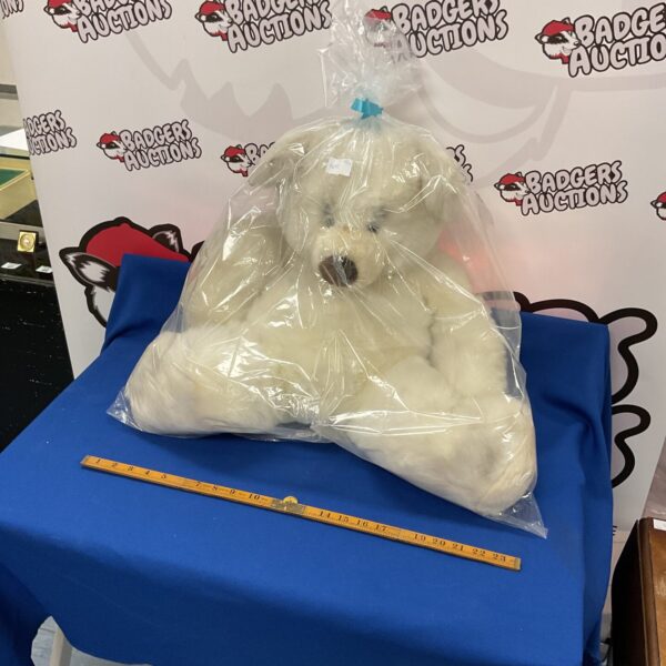 Large white polar bear completely wrapped in gift wrap.