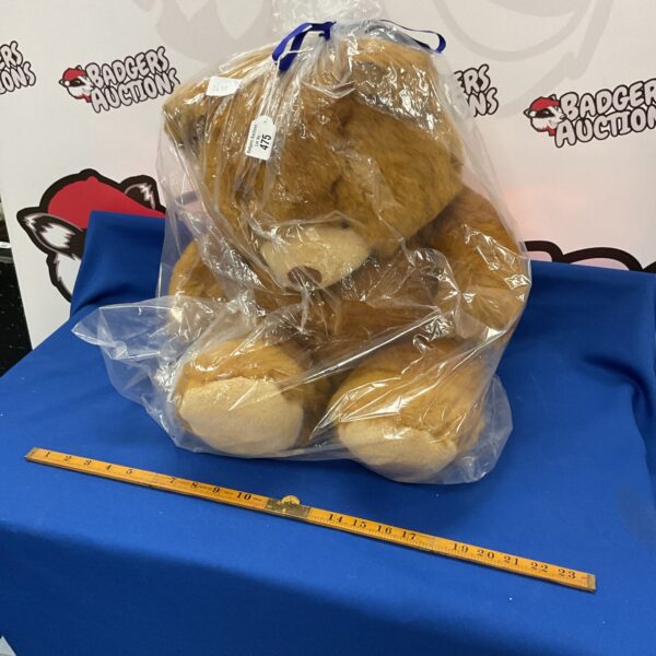 Large gift wrapped teddy bear, a plush toy for display.
