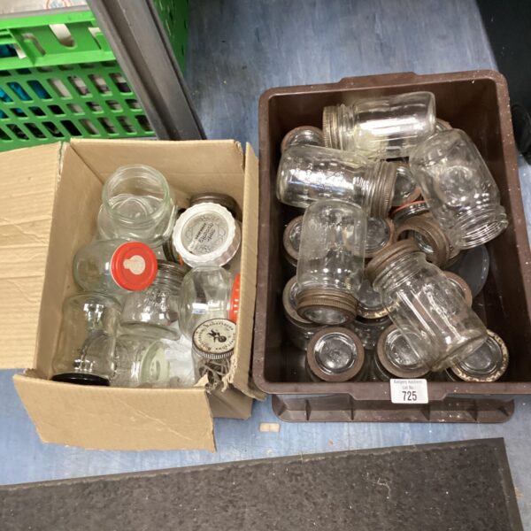 Two boxes filled with vintage Kilner jars for preserving and storage.