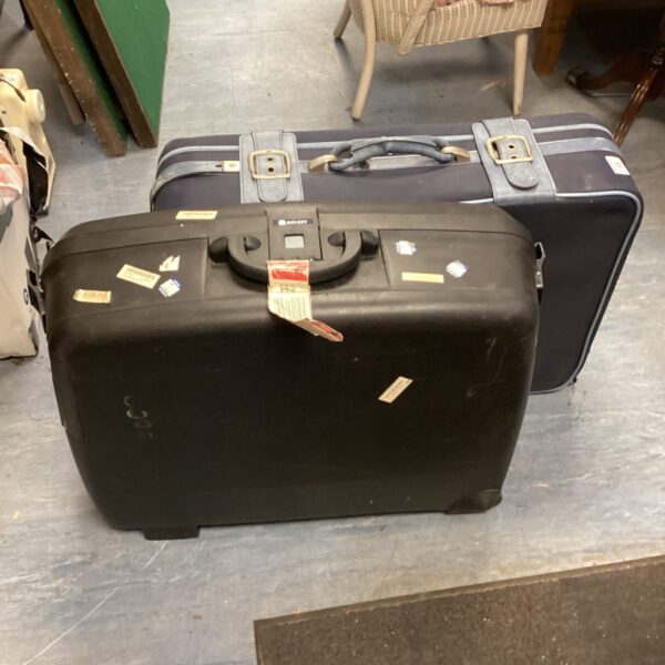 Front view of a vintage Delsey wheeled suitcase.