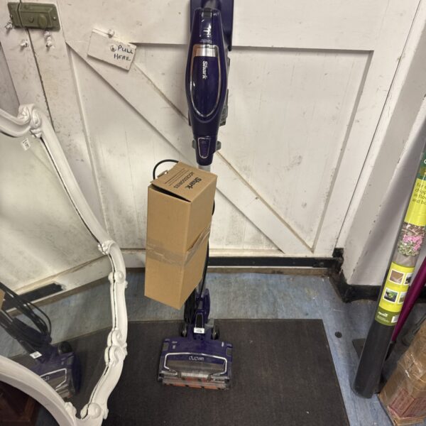 Front view of Shark DuoClean cordless vacuum cleaner with attachments.