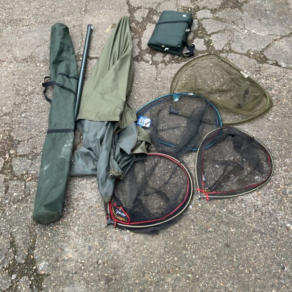 Fishing tackle bundle including nets, mat and umbrella.