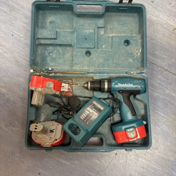 Makita cordless drill in open case with charger and batteries.