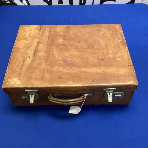 Front view of a vintage brown leather suitcase.