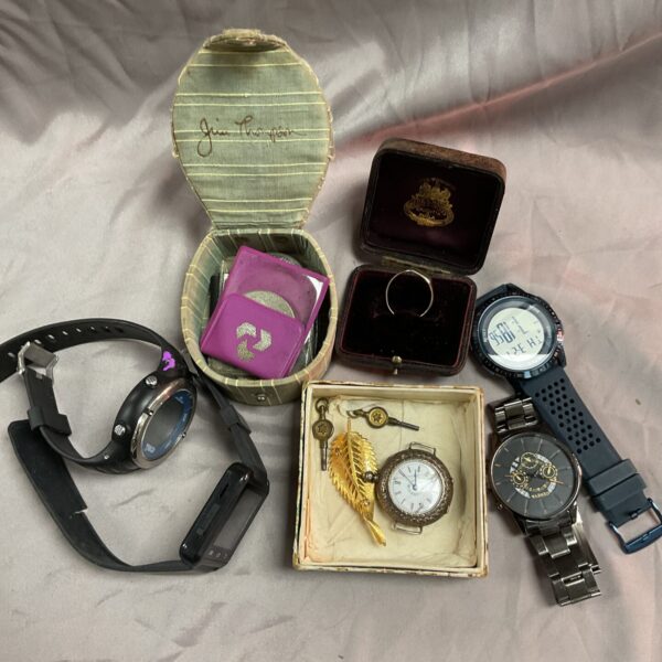 Vintage watch and jewellery lot with black wristwatch and gold timepiece.