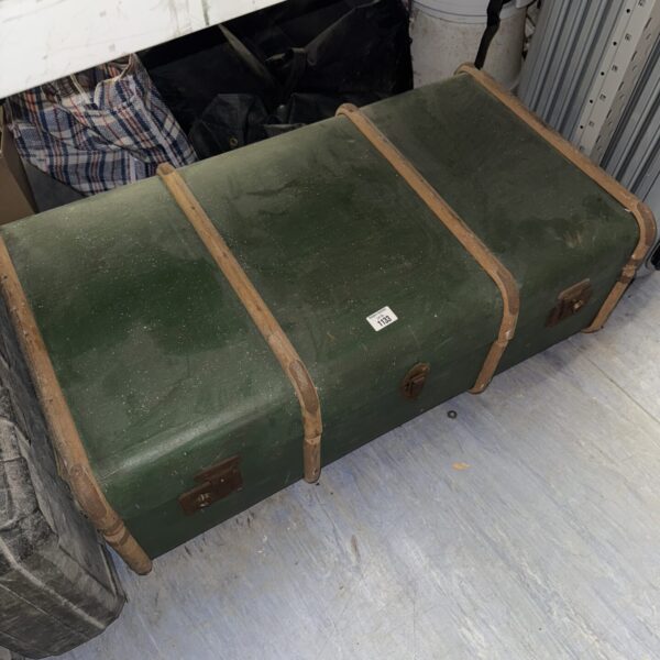 Large vintage steamer trunk with canvas covering and metal accents.