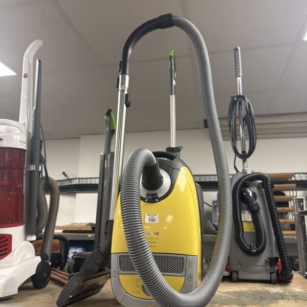 Yellow Miele Compact C2 cylinder vacuum cleaner with hose.