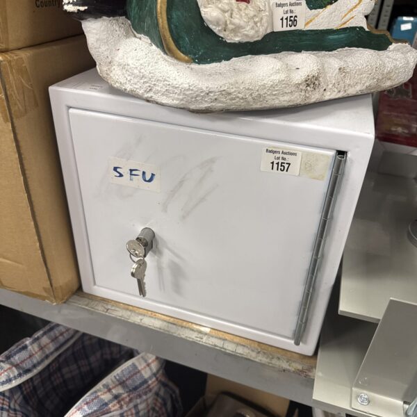 Vintage metal safe with keys, ideal for secure storage.