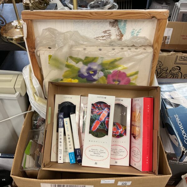Mixed lot of embroidery and crafting supplies with patterns.