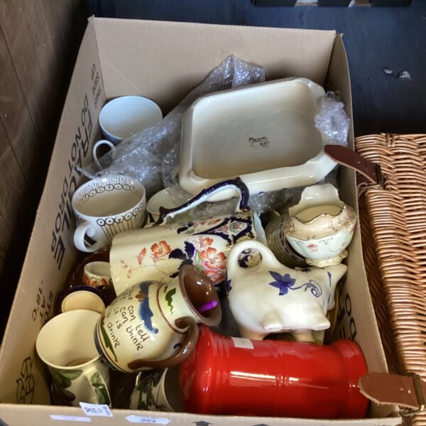 Mixed porcelain lot with jugs, mugs, and decorative items.
