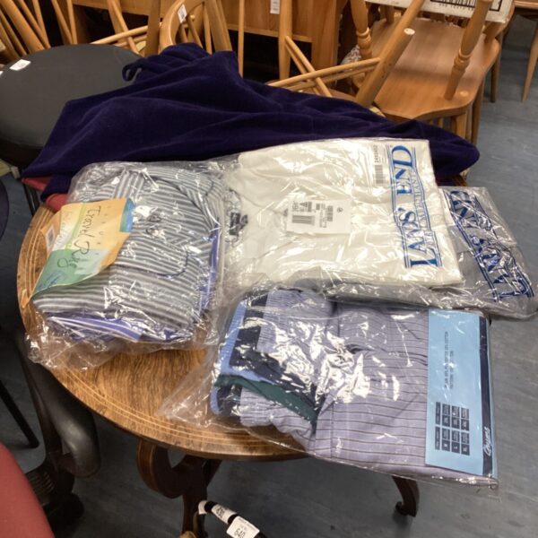 Clothing bundle featuring polo shirts and pyjama bottoms.