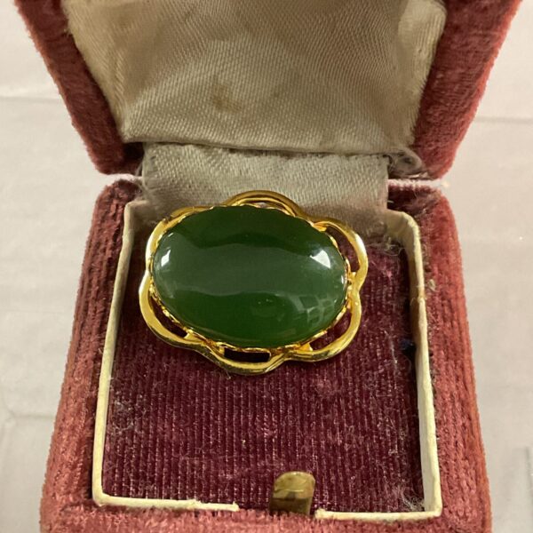 Vintage green jade brooch with gold tone setting.