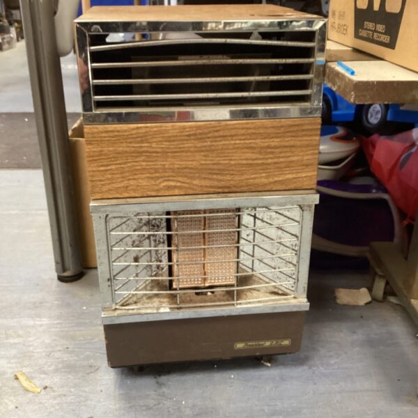 Vintage Calor Gas Heater with wire cage and metal casing.