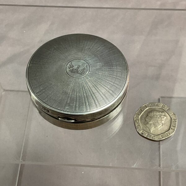 Antique silver pill box with engraved lid and hallmarking.