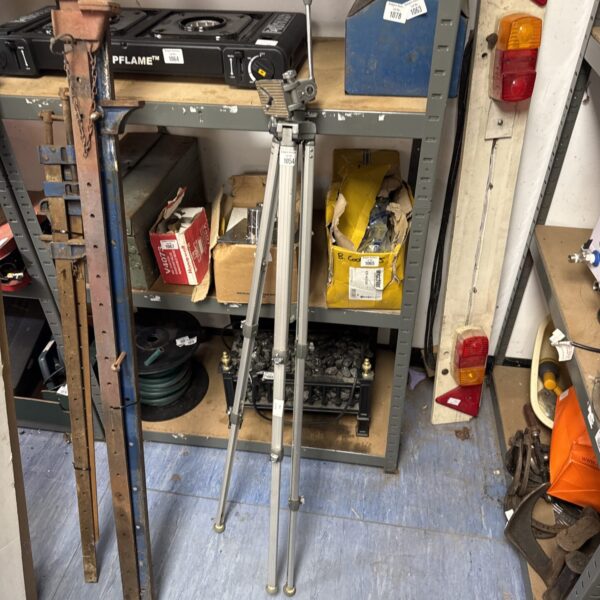 Vintage Velbon camera tripod in a workshop setting.