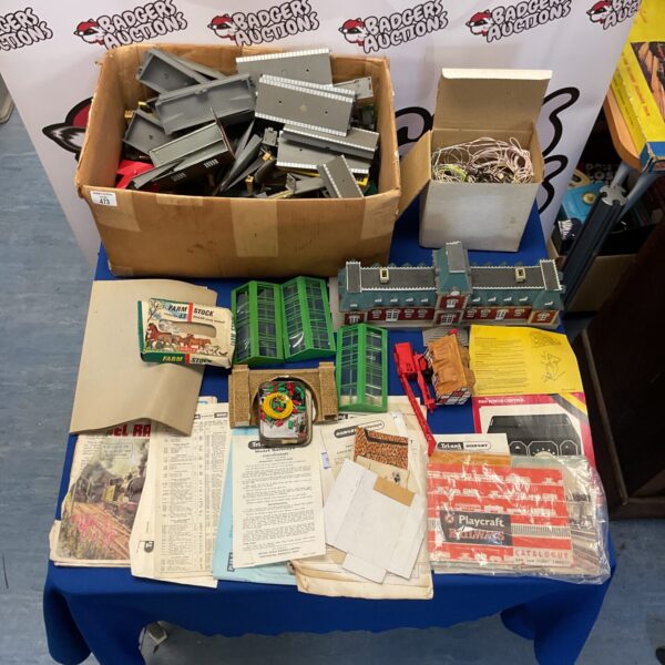 Vintage Hornby railway collection with paperwork and station parts.