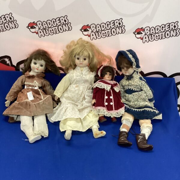 Vintage doll lot with four porcelain dolls in period clothing.