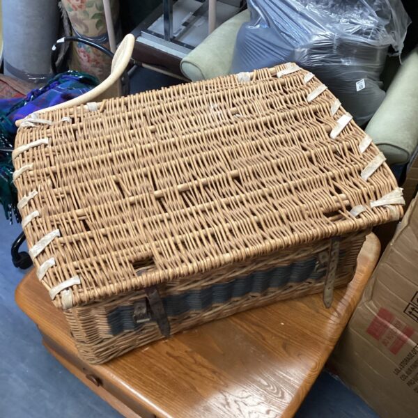 Large vintage wicker basket with a handle, ideal for storage.