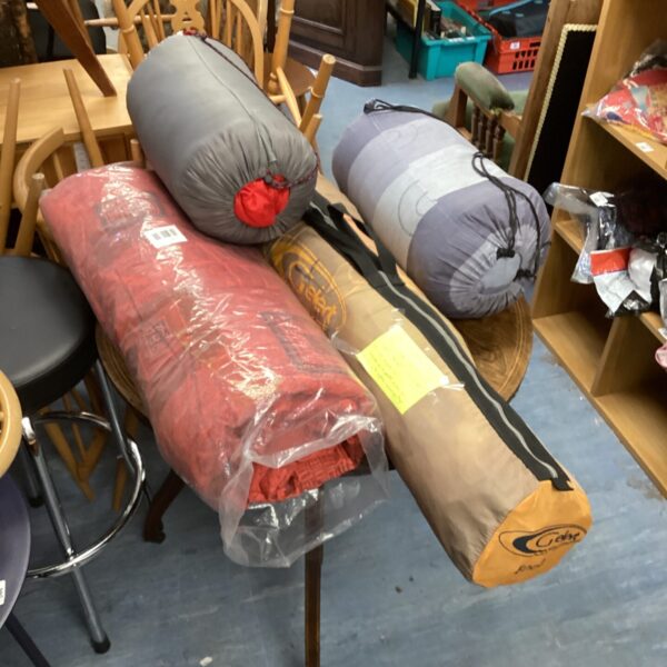 Camping equipment bundle including tent and sleeping bags.