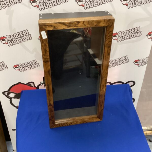 Vintage glass display cabinet for collectibles and curios.