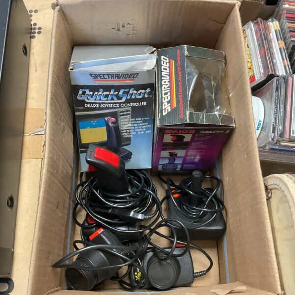Vintage Atari joysticks and paddles lot for retro gaming collectors.