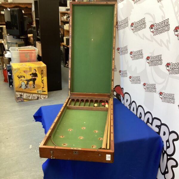 Antique Victorian bagatelle set on a blue table.