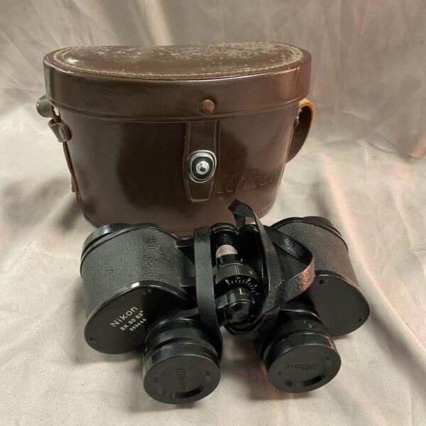 Vintage Nikon 8x 30 binoculars in a protective case.