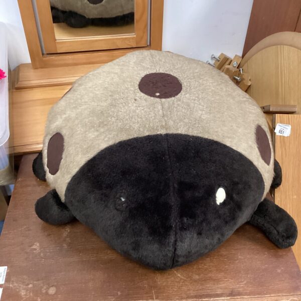 Red and black ladybird pouf for quirky home decor.
