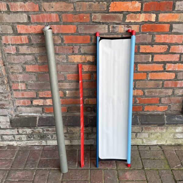 Vintage folding projector screen in blue and silver.