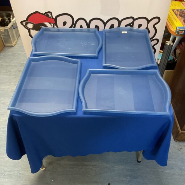 Set of four Ikea plastic serving trays for kitchen use.