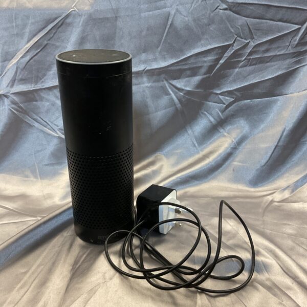 Black Amazon Alexa smart speaker with power adapter.