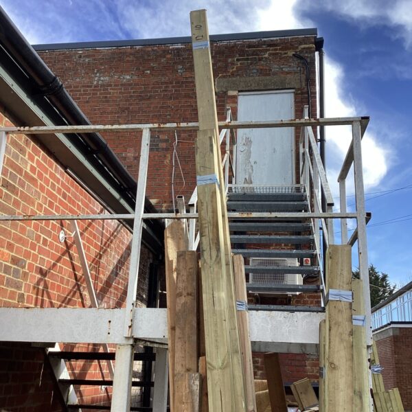 Bundle of timber planks of varying lengths for construction projects.