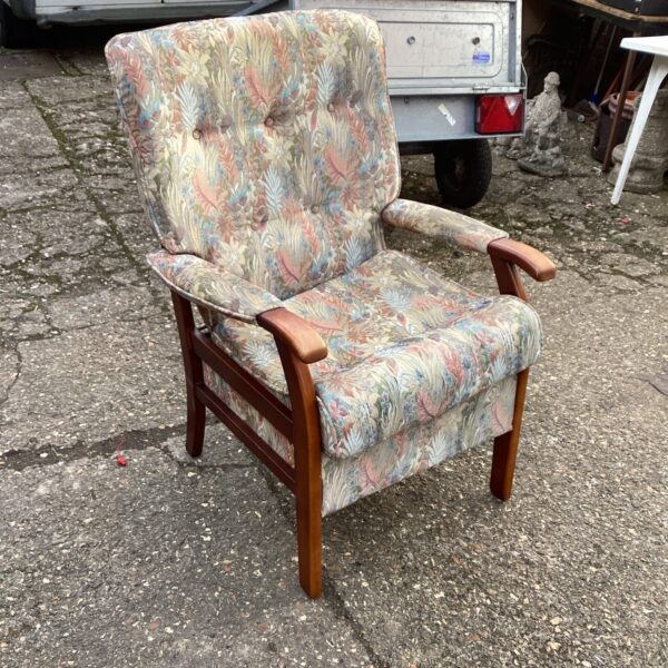 Vintage Ercol chair with patterned upholstery and wooden frame.