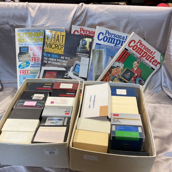 Vintage computing magazines and floppy disks from the 1980s.