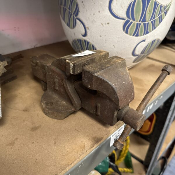 Vintage small bench vice, a metalworking tool for workshops.