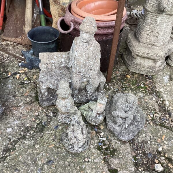 Vintage garden ornaments featuring a Paddington Bear statue.