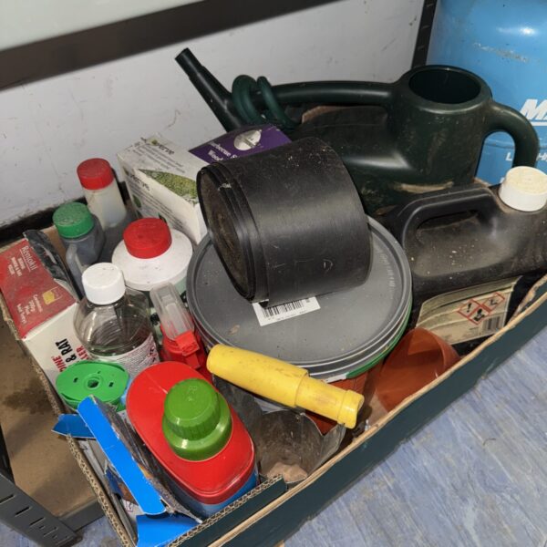 Assorted shed clearance items including cleaning products and containers.