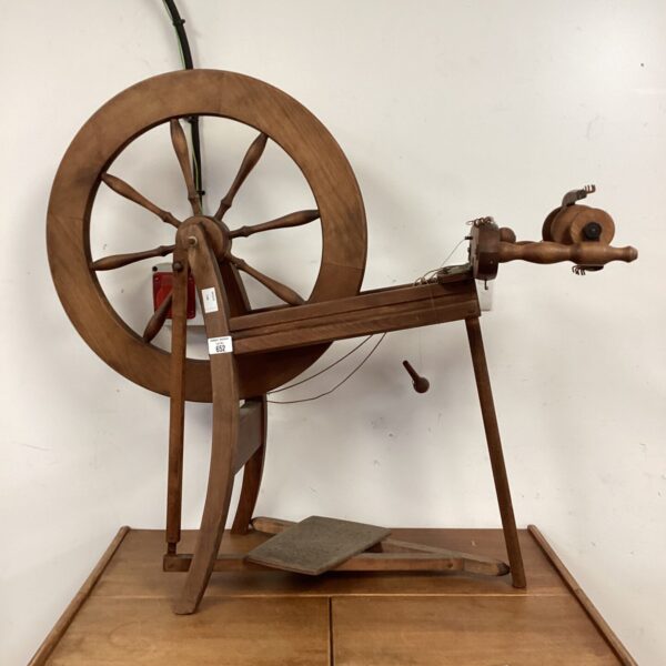 Side view of a vintage reproduction spinning wheel.