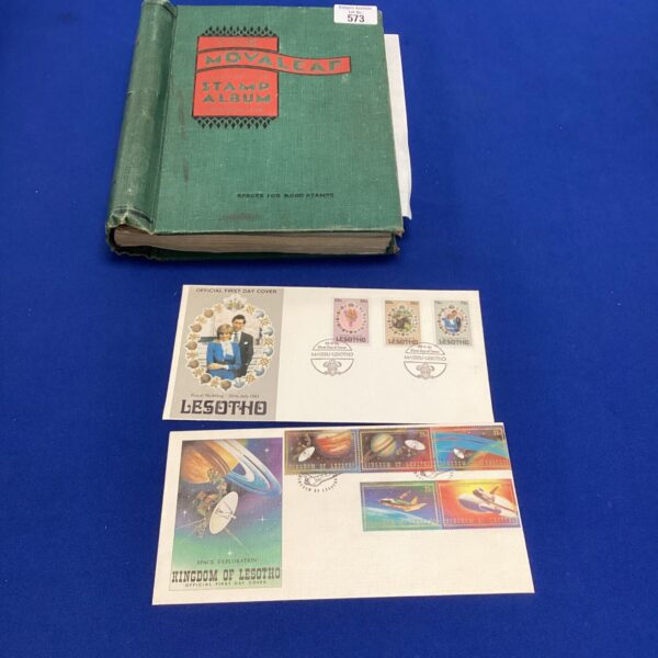 Vintage Movaleaf stamp album with first day covers displayed.