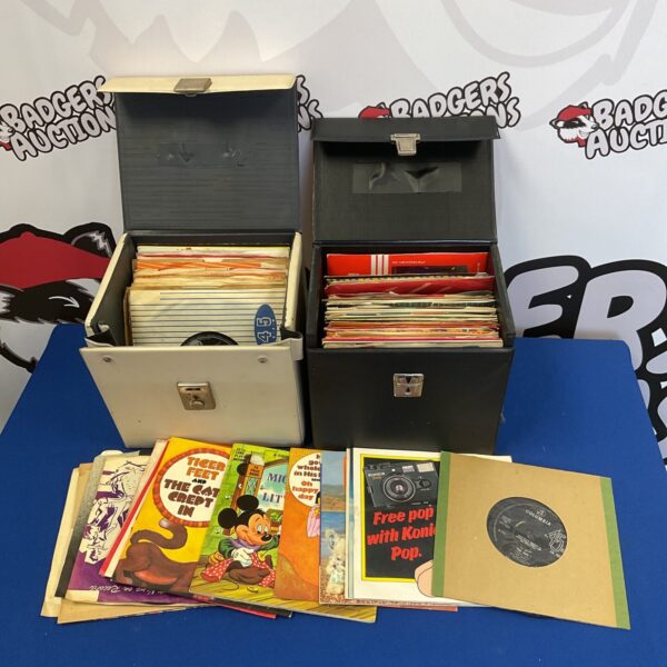 Lot of vintage 7 inch vinyl records in storage cases.