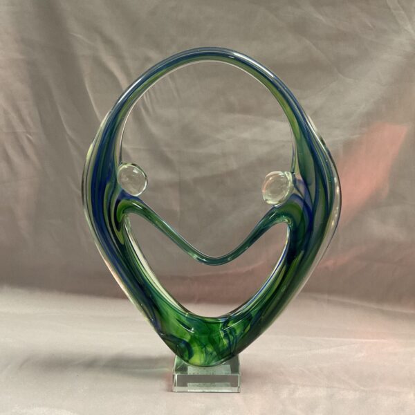 Vibrant blue and green art glass figurine on clear base.