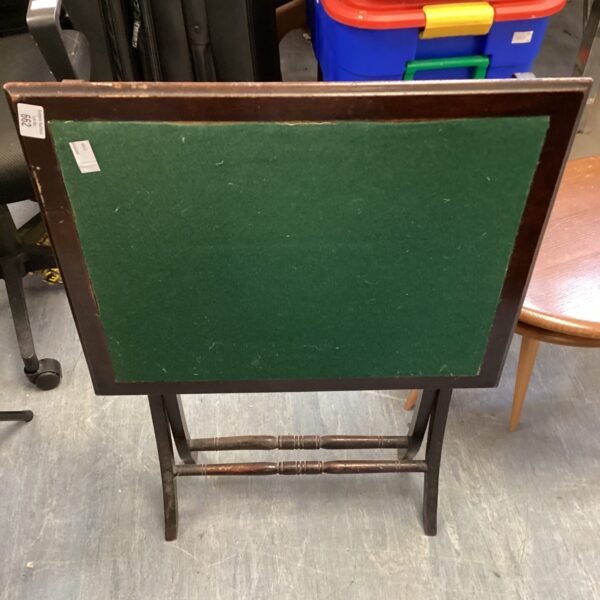 Vintage mahogany folding card table with green felt surface.