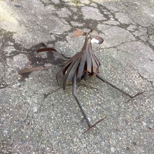 Rustic metal rooster garden ornament with weathered finish.