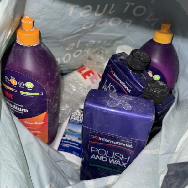 Selection of car polish and cutting compound bottles and containers.