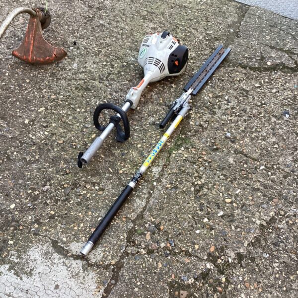 Long-handled Stihl hedge cutter for garden maintenance.