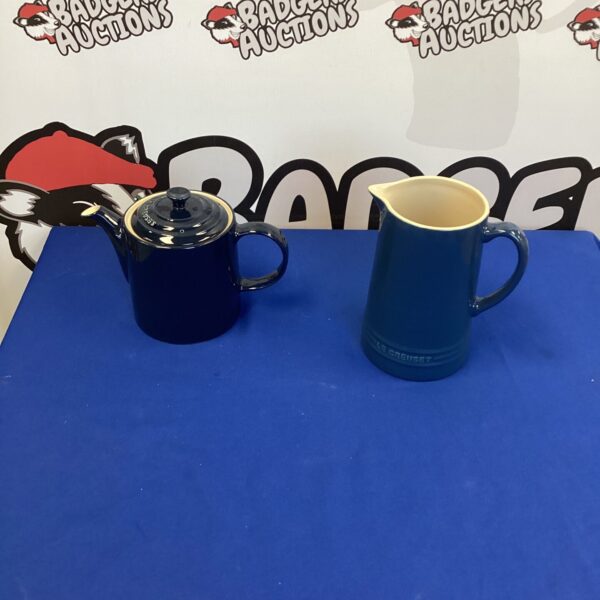 Le Creuset tea set featuring a teapot and matching jug.