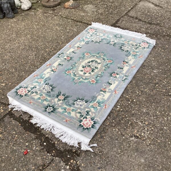 Detailed blue floral runner rug for hallway or home decor.
