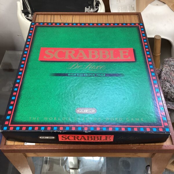 Vintage deluxe Scrabble set with electronic timer and wooden cabinet.