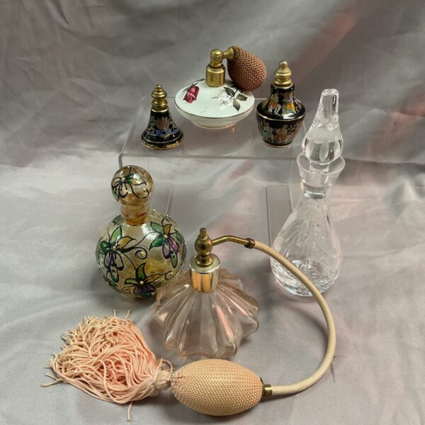 Collection of vintage perfume bottles with colourful detailing.
